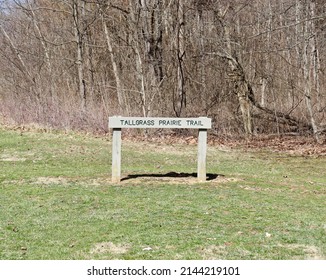 The Old Wood Trail Sign In The Grass On A Sunny Day.