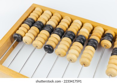 Old wooden abacus isolated on white background - Shutterstock ID 2233417591