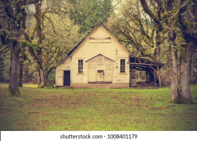 Old Wooden Abandoned One Room School House In The Woods, Forest In Retro Style Tone.