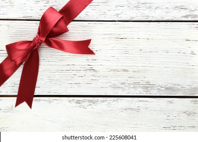 Old wooden background with beautiful bow - Powered by Shutterstock