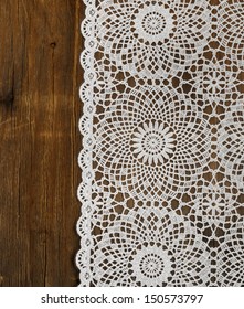 Old Wooden Background With White Lace Napkin