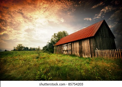 Old wooden bar with red roof over the dramatic sunset. Zalew Zegrzynski, Poland