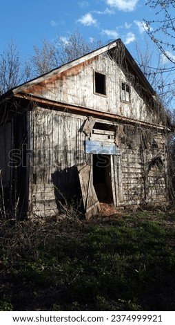 Old wooden barn. Abandoned wooden house. Antique wooden barn