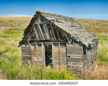 An old wooden barn stands in the fields near Molson, Washington.