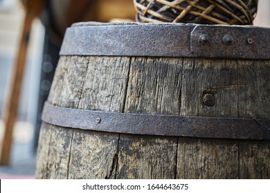 Old wooden barrel on a brown background.