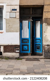 Old Wooden Blue Doors In Wall Of Old Tenement House