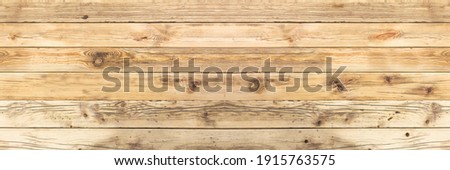 Old wooden boards with cracks and a visible structure as well as gulp and knots. Alder board as a background for various natural designs and compositions. panoramic frame.
