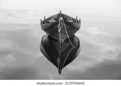 Old Wooden Boat On Still Water In Black And White.