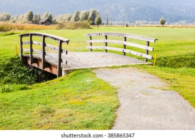 An Old Wooden Bridge On An Idyllic Meadow Or A Beautiful Golf Course