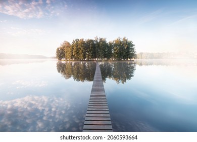Old wooden bridge in park. Beautiful colored trees with lake in autumn, landscape photography. Summer and Late autumn. Outdoor and nature.
Amazing foggy morning. Lake coast. Fog over autumn lake water