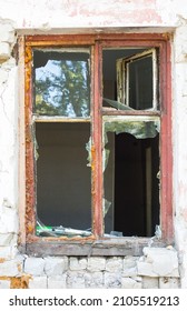 Old wooden broken window in a brick house