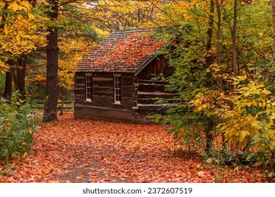 Old wooden  cabin in the autumn forest, Fall in Canada, Heritage village in Canada, Ontario - Powered by Shutterstock