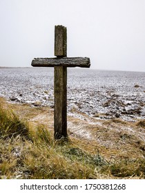 Old Wooden Catholic Cross Against Blue Sky And White Clouds In Sunny Weather, Closeup Of Religious Symbols In Winter