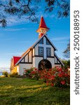 The old wooden chapel "Notre-Dame Auxiliatrice" with its red roof and white façade in Cap Malheureux in the north of the tropical vacation island of Mauritius is a landmark, sight and monument.