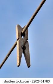 An Old Wooden Clothespin Hanging On A Rope On An Autumn Day