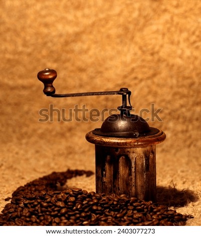 old wooden coffee grinder and roasted ecological coffee beans