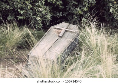 An Old Wooden Coffin With A Cross On Top