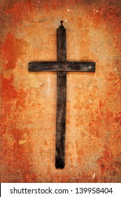 Old Wooden Cross On A Grunge Crumbling Wall