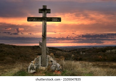 Old Wooden Cross On Hill Top Against Sunset Sky