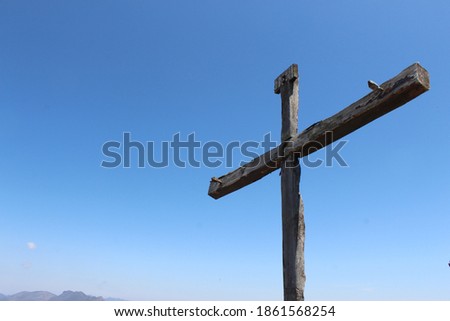 Old wooden cross on top of the mountain