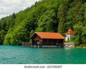 Old wooden dock houses on the lake with typical wooden pier, the Walchensee in Bavaria Germany - Powered by Shutterstock