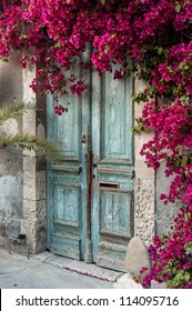 Old wooden door with bougainvillea in Cyprus