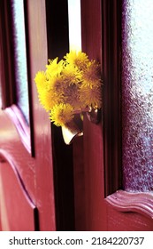 Old Wooden Door With Glass Window And Vintage Doorknob And Summer Bouquet Of Yellow Dandelions. Cozy Simple Authentic Life