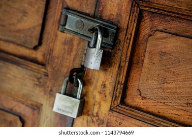 Old Wooden Door Locked With Two Metal  Security Padlocks, Double Lock Top Secret.