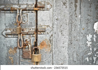 Old Wooden Door With Many Rusty Locks