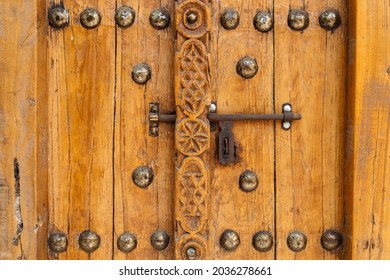 An old wooden door with metallic latch, closed, close up, Unaited Arab Emirates - Powered by Shutterstock