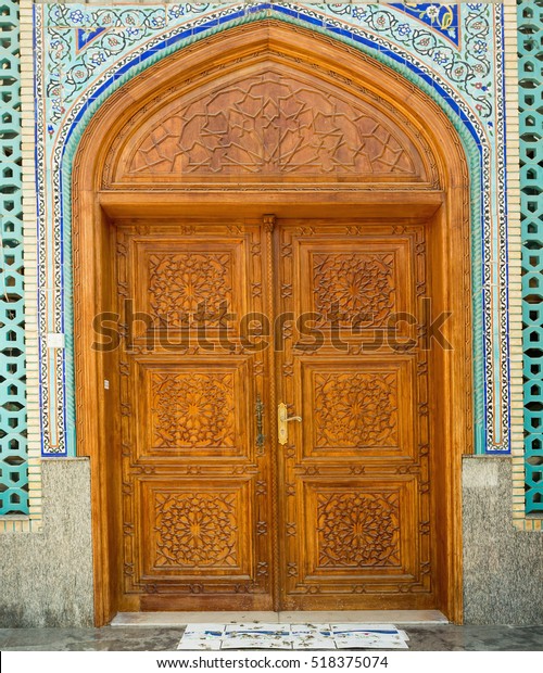 Old wooden door to the mosque, hand-crafted. Ali\
bin Abi Taleb Mosque in old city Deira Dubai. The creek is divides\
the city into two main sections Deira and Bur Dubai old downtown of\
Dubai.