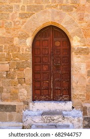 old wooden door on an ancient stone wall