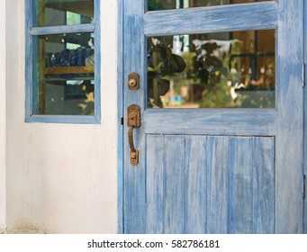 Old wooden door and rusty iron handle - Shutterstock ID 582786181