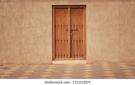 old wooden door in a stone wall, Arabic style construction                              - Powered by Shutterstock