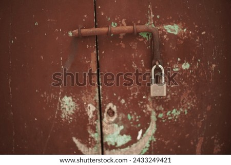 Old wooden door vintage. Hasp with lock,
deadbolt with lock