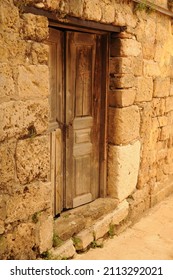 Old Wooden Door Within An Old Stone Wall