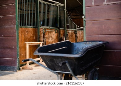 Old Wooden Empty  Stable Barns And Wheel Barrow On Horse Ranch