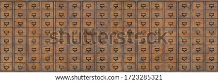 Old wooden filing cabinet or organizer for storing registration cards and library accounting. Wooden document repository in past centuries, pre-computer era and big data. Seamless wooden file cabinet.