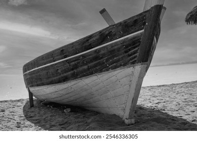 Old wooden fishing boat on the beach and sky up the horison in black and white" - Powered by Shutterstock