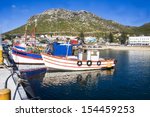 Old wooden fishing boats moored in Kalk Bay Harbour, Cape Town, South Africa