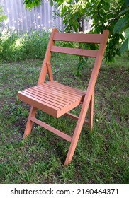 Old Wooden Folding Chair In The Garden