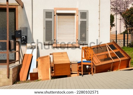 Old wooden furnitures and bulky waste in front of a house