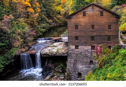 Old wooden house in the woods by the stream. Cold creek at river house in woods. Forest river house by the creek. Forest creek house