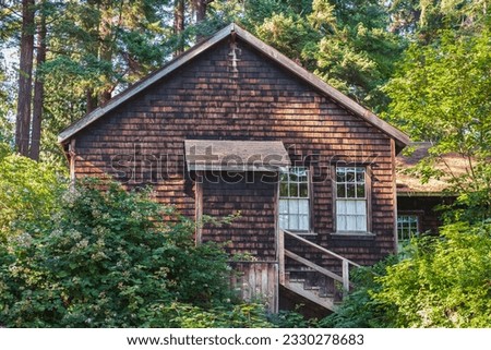 Old wooden house in woods. House made of wood in the forest. Wooden cabin. Travel photo, nobody