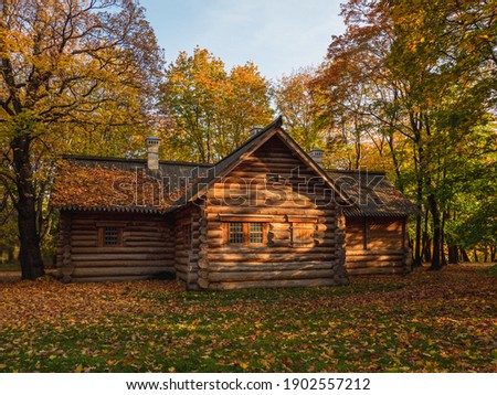 Old wooden log cabin in the autumn forest. The house of Peter I in Kolomenskoye in Moscow.