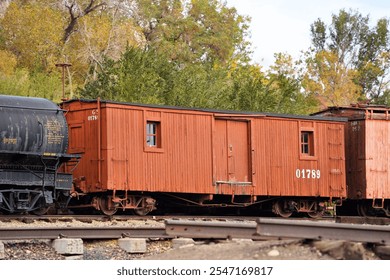 An Old Wooden Outfit Car in a Freight Train Consist - Powered by Shutterstock