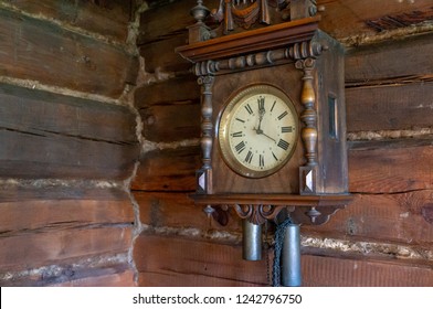 Old wooden pendulum hanging on a wall