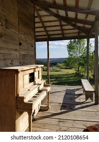 Old Wooden Piano On Porch Outside Of Western Cabin Utah