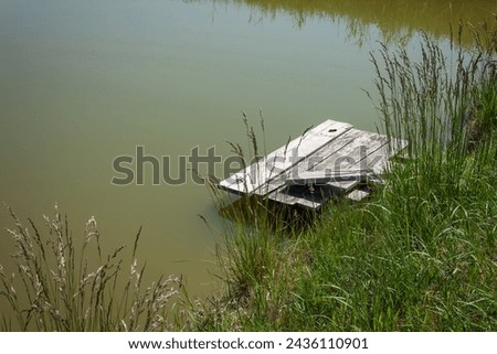 Old wooden pier on the background of water