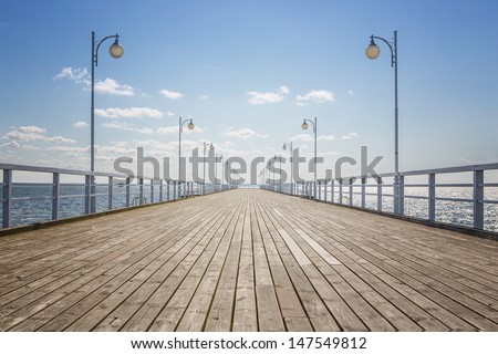 Old wooden pier over the sea shore with copy space